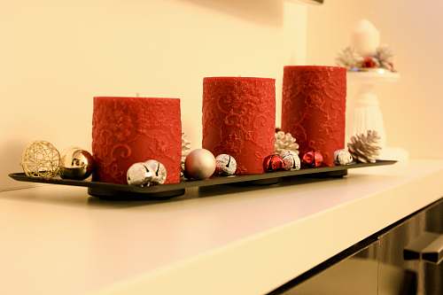 furniture three red pillar candles on black holder table